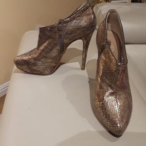 Women leather gold shoes .